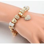 Arany színű charm karkötő cirkóniás charmokkal és szív medállal